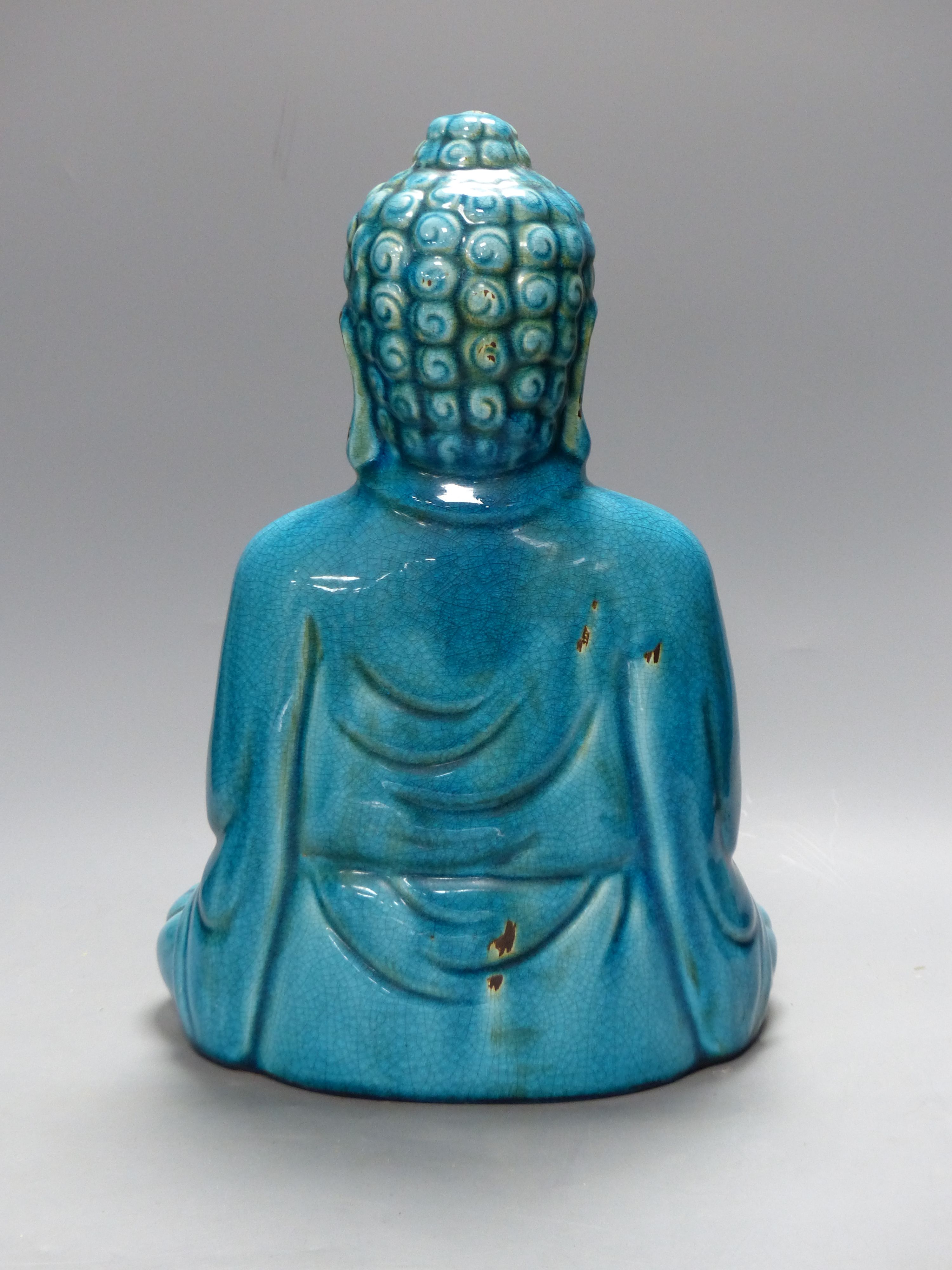 A Chinese ceramic buddha, height 40cm, a blue and white dish, and two leather wall hangings, Qing period or later